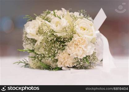 Bridal bouquet of white rose on blur background