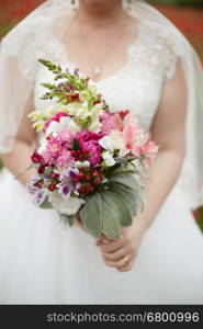 Bridal bouquet. Wedding bouquet in hands of the bride.