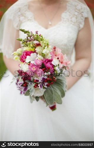 Bridal bouquet. Wedding bouquet in hands of the bride.