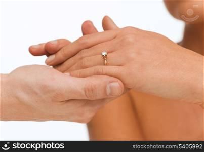 bridal, couple, jewellery, wedding, luxury concept - man puts wedding ring on woman hand