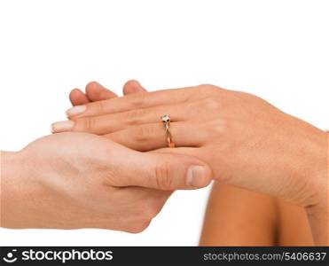 bridal, couple, jewellery, wedding, luxury concept - man puts wedding ring on woman hand
