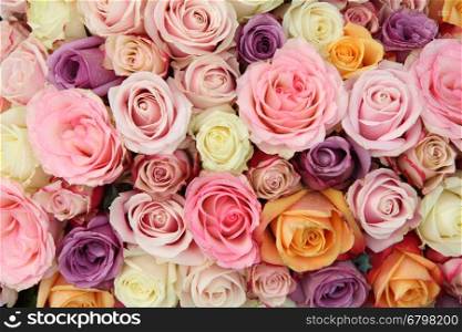 Bridal flower arrangement in various shades of pink, combined with white and purple
