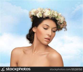 bridal, spring and beauty concept - young woman wearing wreath of flowers