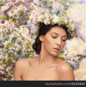 bridal, spring and beauty concept - young woman wearing wreath of flowers