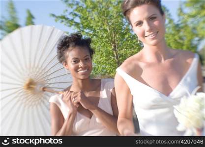 Bride and Bridesmaid with Young Tree