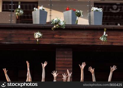 bride and bridesmaids throwing bouquets up, sunny wedding reception. joyful moment. bride with girls having fun in wedding morning. bride and bridesmaids throwing bouquets up, joyful moment. bride with girls having fun in wedding morning