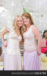 Bride and Friend standing Together holding balloons at Bridal Shower