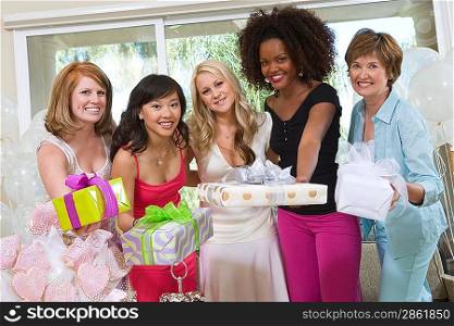 Bride and Friends standing Together holding gifts at Bridal Shower
