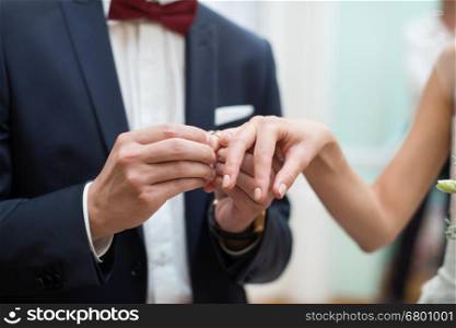 bride and groom are changing rings on wedding ceremony