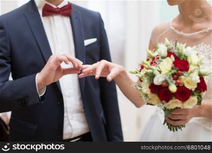 bride and groom are changing rings on wedding ceremony