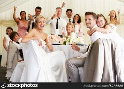 Bride And Groom Celebrating With Guests At Reception