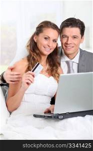 Bride and groom doing shopping on inernet at home