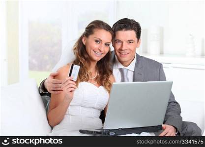 Bride and groom doing shopping on inernet at home