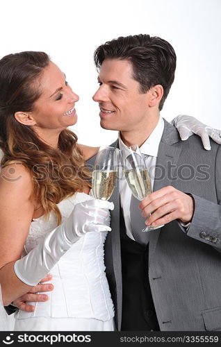 Bride and groom drinking champagne