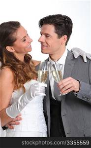Bride and groom drinking champagne