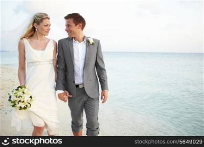 Bride And Groom Getting Married In Beach Ceremony