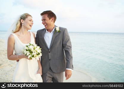 Bride And Groom Getting Married In Beach Ceremony