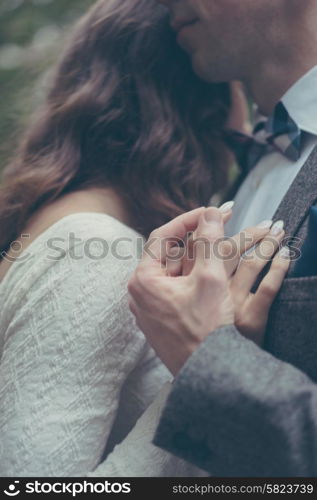 Bride and groom holding hands in vintage pastel colors