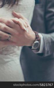 Bride and groom holding hands in vintage pastel colors