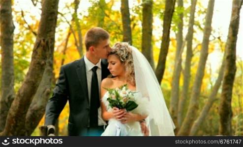 bride and groom in the autumn park