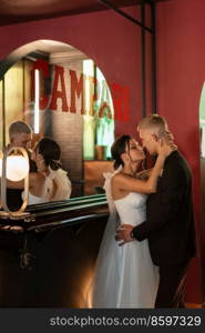 bride and groom inside a cocktail bar in a vibrant atmosphere