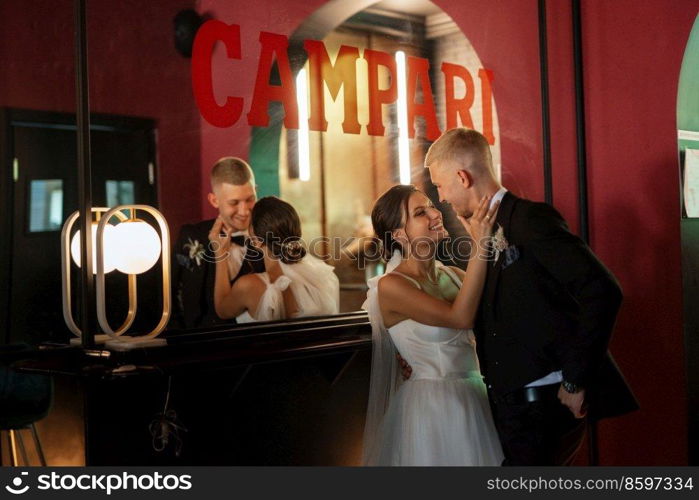 bride and groom inside a cocktail bar in a vibrant atmosphere