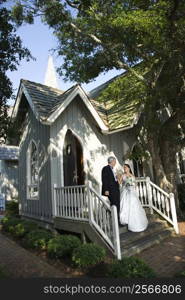 Bride and groom leaving church together.