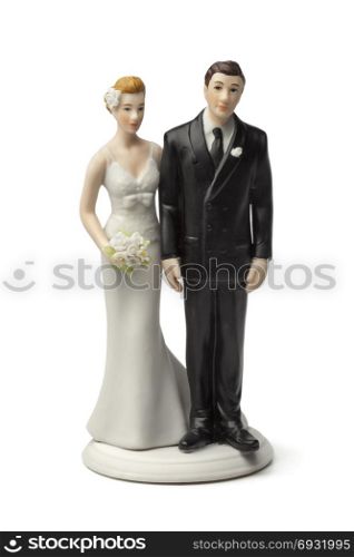 Bride and groom, old plaster cake topper on white background