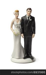 Bride and groom, old plaster cake topper on white background