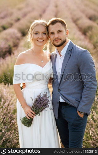 bride and groom on a walk in the lavender field