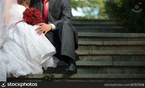 bride and groom sit on the stairs