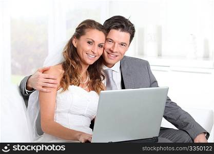 Bride and groom surfing on internet