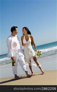 Bride and Groom Walking on Beach