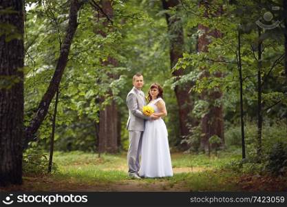 bride and groom wedding walk in park in summer