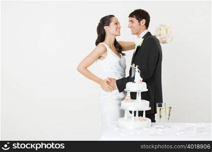 Bride and groom with a wedding cake