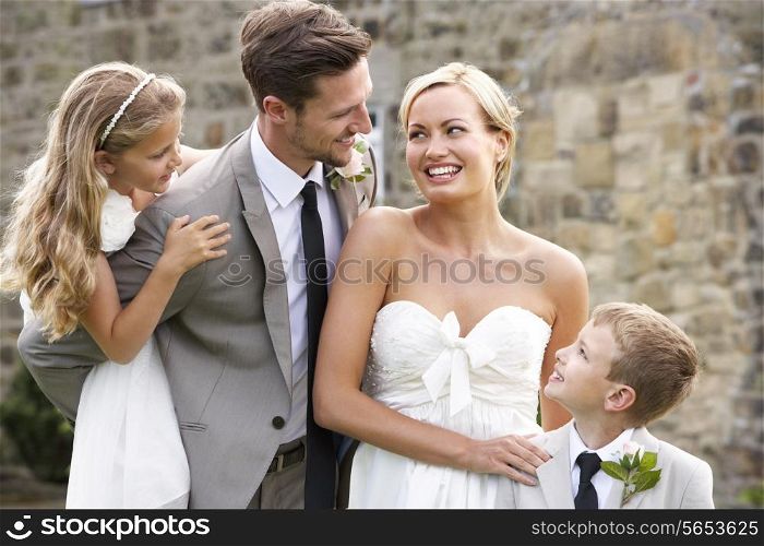 Bride And Groom With Bridesmaid And Page Boy At Wedding