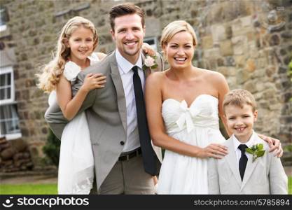Bride And Groom With Bridesmaid And Page Boy At Wedding