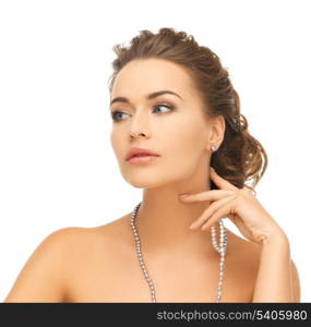 bride and wedding concept - beautiful woman wearing pearl earrings and necklace