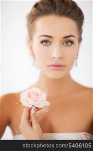 bride and wedding concept - young woman with rose flower