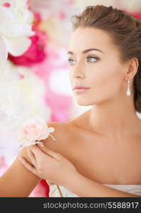 bride and wedding concept - young woman with rose flower