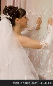 Bride are smiling and look at window