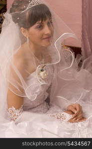 Bride are smiling under wedding veil