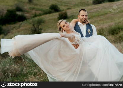 bride blonde girl and groom in a field at sunset light