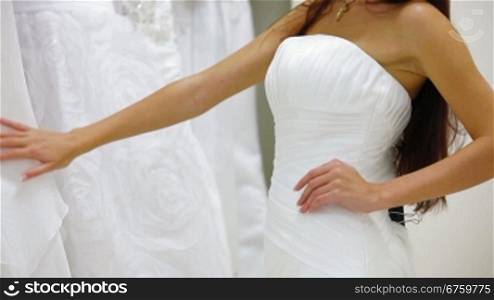 Bride Choosing Wedding Dress in Bridal Boutique