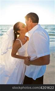 Bride & Groom Married Couple Kissing at Sunset Beach Wedding