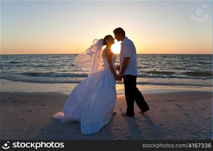 Bride & Groom Married Couple Kissing Sunset Beach Wedding