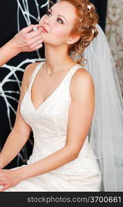 Bride having her makeup applied