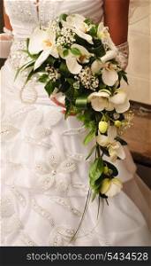 Bride hold the bouquet from white orchids
