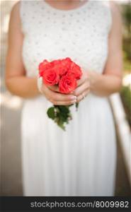 Bride holding a bouquet of beautiful roses