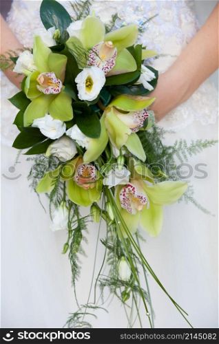 bride holding a bouquet of flowers on her wedding day. bride holding a bouquet